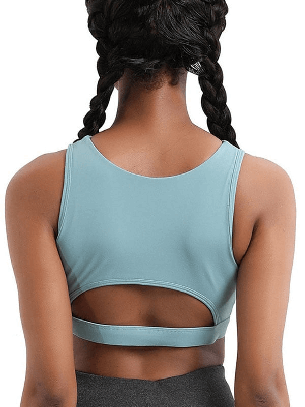 Back view of athletic women's sports bra in blue, designed for yoga and fitness, showcasing cutout detail and breathable fabric.